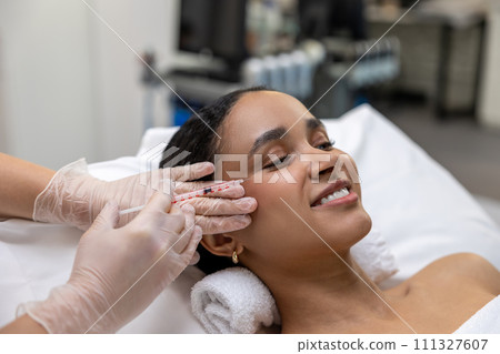 Young dark-skinned woman having a session of mesotherapy 111327607