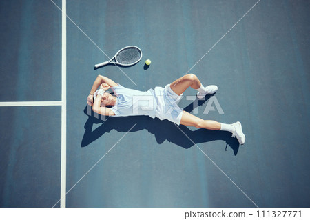 Tired tennis sports loser man on floor with racket, ball and court in summer sun from above. Relax and fitness player lying on ground, resting or taking break after match, game or outdoor practice 111327771