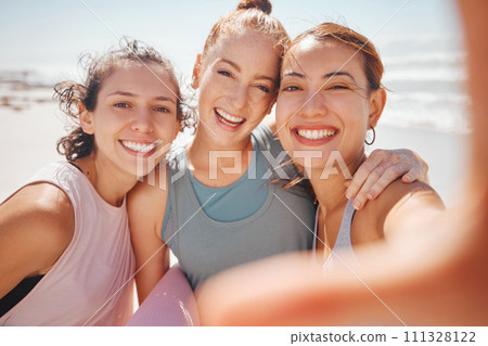 Happy and sport friends selfie at the beach after workout, exercise or training yoga class or pilates. Portrait of smile, fitness or cheerful women bonding, having fun and standing at the ocean 111328122