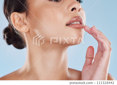Beauty, skincare and health, a woman on a blue background. Morning skin care, anti aging treatment and makeup routine. Lips, collagen and youth, a young female grooming with beautiful mouth 111328442