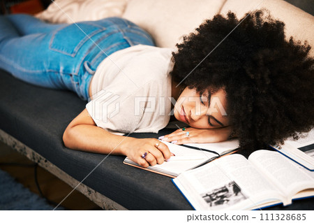 Education, learning and sleeping with a tired, exhausted and overworked woman student studying on a sofa in her home. Burnout and exhaustion with a female learner in her house to study and learn Education, learning and sleeping with a tired, exhausted and overworked woman student studying on a sofa in her home. Burnout and exhaustion with a female learner in her house to study and learn 111328685