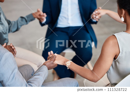 Support, trust and collaboration with a group of business people holding hands while sitting in circle for a team building workshop. Pray, motivation and diversity in a corporate office or workplace 111328722