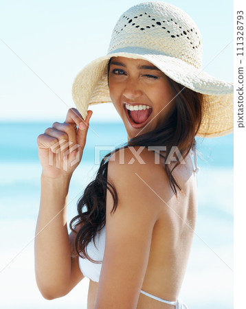 Wink, portrait and happy woman on beach with hat, bikini and excited for summer holiday in Australia. Smile, sun and face of girl on ocean vacation with adventure, travel and relax on tropical island Wink, portrait and happy woman on beach with hat, bikini and excited for summer holiday in Australia. Smile, sun and face of girl on ocean vacation with adventure, travel and relax on tropical island 111328793