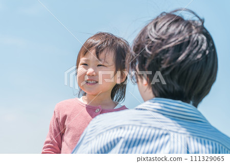 Active child (girl) playing with her parents in the grassland/park Active child (girl) playing with her parents in the grassland/park 111329065