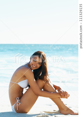 Arab female, beach and bikini for ocean, waves and breeze for summertime in Bali for vacation. Woman, sea and holiday relaxation abroad in swimsuit, sand and smile for portrait, memories and trip. 111329135