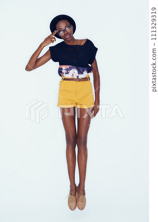 Portrait, fashion and glasses with black woman in studio, full length of white background for hipster style. Model, clothes and funky with confident young african person in trendy clothing outfit 111329319