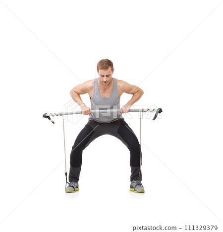 Fitness, workout and resistance band with a strong man in studio isolated on a white background for health. Gym, exercise or performance and a young athlete training with equipment for wellness 111329379