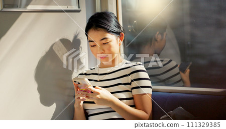 Asian woman, train and travel with smartphone and communication, commute or adventure with transport. Email, chat and scroll social media with tourism in Japan, public transportation and mobile app 111329385