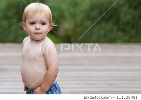 Baby, playing on porch outdoor for development with mockup, curiosity or early childhood in backyard of home. Toddler, child and relax in garden for wellness, milestone and exploring or innocent 111329481