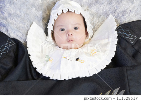 A half-Japanese baby boy looking at the camera and taking a photo while visiting a shrine 111329517