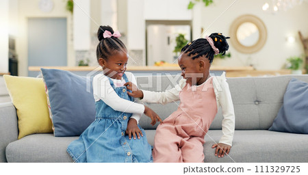 Kids, play and couch in a home with poke, smile and happy from sibling bonding together. House, lounge sofa and daughter friends with game and girl friendship with fun and youth in a living room Kids, play and couch in a home with poke, smile and happy from sibling bonding together. House, lounge sofa and daughter friends with game and girl friendship with fun and youth in a living room 111329725