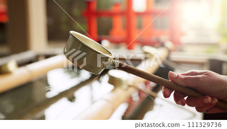 Shinto shrine, hands and fountain with water in container for faith, clean or washing for wellness. Religion, culture and praise with ladle for purification ritual in woods, peace or temple in Kyoto Shinto shrine, hands and fountain with water in container for faith, clean or washing for wellness. Religion, culture and praise with ladle for purification ritual in woods, peace or temple in Kyoto 111329736