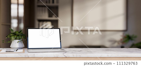 Close-up image of a white-screen laptop mockup on a white marble tabletop in a modern room. 111329763