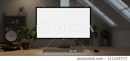 A computer desk with a computer mockup and accessories on a hardwood table in a room. 111329773