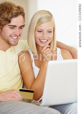 Couple, credit card and thinking on computer for online shopping, loan choice or digital money on sofa at home. Happy woman and man on laptop for internet banking, website payment or e commerce ideas 111329892