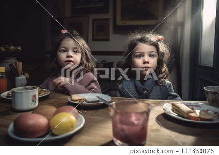 Twin girls having breakfast in a Parisian apartment 111330076