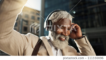 Happy, dancing and senior businessman with headphones in the city walking and listening to music. Smile, happy and elderly African male person streaming playlist, song or radio commuting in town. Happy, dancing and senior businessman with headphones in the city walking and listening to music. Smile, happy and elderly African male person streaming playlist, song or radio commuting in town. 111330096