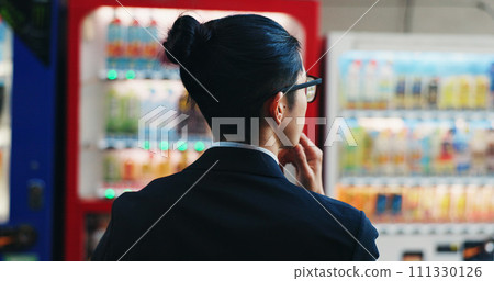 Vending machine, business man and choice, decision or thinking of automatic service technology at night in city outdoor. Back, shopping and hungry professional customer in urban town in Tokyo Japan 111330126