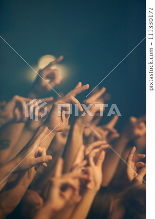 Rock concert, hands and music festival with people, event and party with fun and entertainment. Freedom, energy or crowd screaming with excitement and social with audience or group with performance 111330172