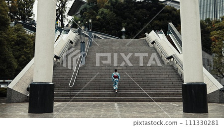 Japan, woman and kimono outdoor on stairs for wellness, heritage celebration and culture in Tokyo city. Sanno Torii, person and walking on steps for travel, spiritual journey and traditional fashion 111330281