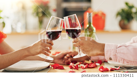 Couple, hands and toast with wine glass for home celebration of love, romance and valentines day on anniversary. People, table and date success with red champagne, drinks or luxury dinner with roses 111330411