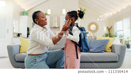 Talking, happy and a mother with a child getting ready for school in the morning. Kiss, laughing and an African mom helping a little girl with a bag in the living room of a house for kindergarten 111330414