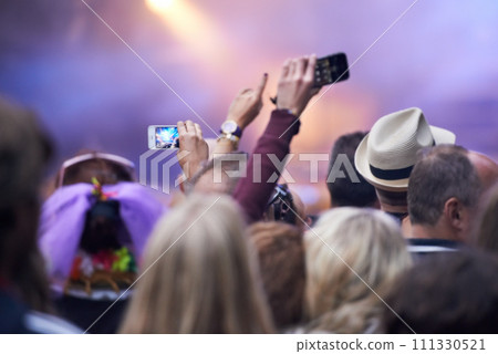 People, festival and crowd in music concert, cellphones and audience for event, entertainment and back. Technology, fun and gathering for rock and roll, celebration and performance for live streaming 111330521