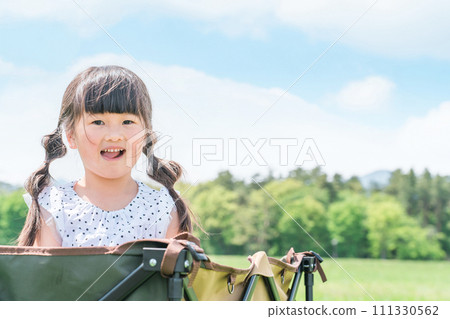 Children playing on a carry wagon in the outdoors/park (girls/camping) Children playing on a carry wagon in the outdoors/park (girls/camping) 111330562