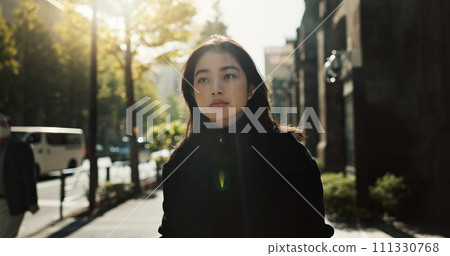 Walking, trees and Japanese woman in the city for tourist sightseeing in the street on weekend trip. Serious, adventure and young female person commuting in road of urban town in Kyoto Japan. Walking, trees and Japanese woman in the city for tourist sightseeing in the street on weekend trip. Serious, adventure and young female person commuting in road of urban town in Kyoto Japan. 111330768