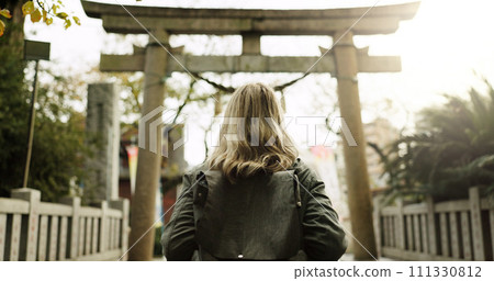 Woman, nature and torii gate in Kyoto with backpack, tourist and back with traditional history. Architecture, japanese culture and shinto shrine in woods with sculpture, memorial and monument Woman, nature and torii gate in Kyoto with backpack, tourist and back with traditional history. Architecture, japanese culture and shinto shrine in woods with sculpture, memorial and monument 111330812