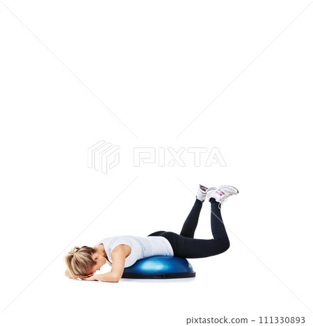 Woman, bosu ball and lying in fitness for balance, exercise or workout on a white studio background. Young active female person or athlete on half round object for health and wellness on mockup space 111330893