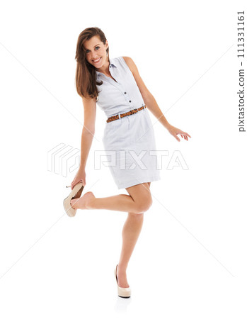 Woman, fitting high heels and studio portrait for trendy style, balance or feet by white background. Girl, person and shoes for size check, edgy clothes or outfit choice for test, product and fashion 111331161