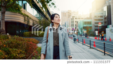 Woman, Asian and walking, travel or commute to work with professional in city with earphones. Listening to music on journey, podcast and commuter on urban street or sidewalk in Tokyo with playlist 111331377