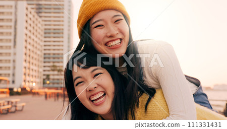Friends, women and piggyback outdoor on promenade with bonding, laughing and adventure on holiday or vacation. Travel, Japanese people or embrace at beach in city with fun, comedy or freedom together 111331431