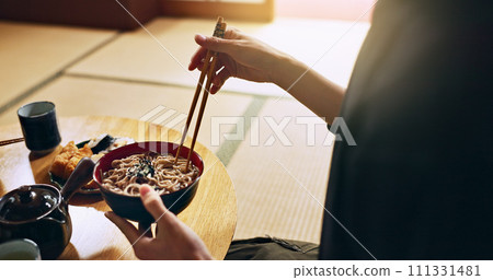 Closeup of bowl of noodles, hands and man is eating food, nutrition and sushi with chopsticks in Japan. Hungry for Japanese cuisine, soup and Asian culture with traditional meal for lunch or dinner Closeup of bowl of noodles, hands and man is eating food, nutrition and sushi with chopsticks in Japan. Hungry for Japanese cuisine, soup and Asian culture with traditional meal for lunch or dinner 111331481