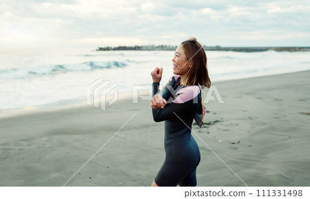 Surfer, beach and woman with stretching, exercise and vacation with getaway trip, workout and training. Person, Japan and girl with ocean, waves and fitness with warm up, muscle and wellness Surfer, beach and woman with stretching, exercise and vacation with getaway trip, workout and training. Person, Japan and girl with ocean, waves and fitness with warm up, muscle and wellness 111331498