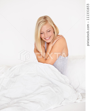 Smile, wake up and cozy in bed with woman in hotel for hospitality or accommodation on vacation. Relax, self love and morning hug with happy young person in bedroom of home, apartment or guest house 111331653