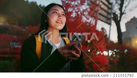 Happy asian woman, phone and night for communication, social media or outdoor networking in city. Female person relax on mobile smartphone in late evening for online chatting in urban town of Japan Happy asian woman, phone and night for communication, social media or outdoor networking in city. Female person relax on mobile smartphone in late evening for online chatting in urban town of Japan 111331792