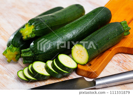 Close-up of fresh green zucchini cut on wooden desk 111331879