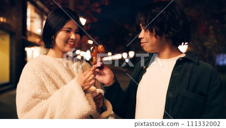 Women, friends and eating street food or travel Japan for night snack, experience or dessert. Female people, sidewalk and sweet donut on vacation for nutrition or culture, adventure or traditional 111332002