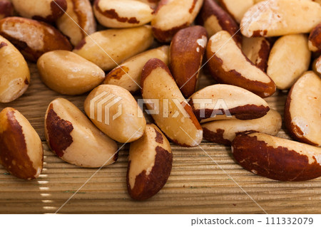 Brazil nuts on wooden surface, closeup Brazil nuts on wooden surface, closeup 111332079