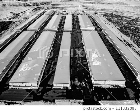 Drone view of a rental storage unit facility with closed bay doors. 111332095