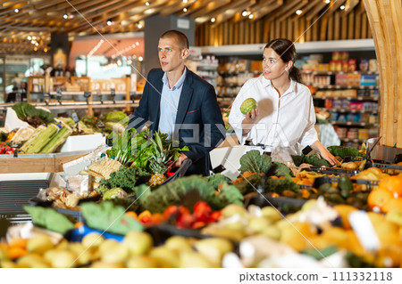 Portrait of a confident young couple in the supermarket Portrait of a confident young couple in the supermarket 111332118