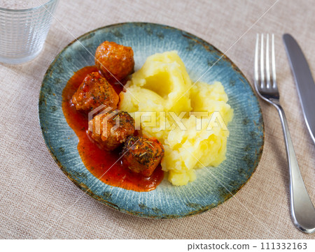 Meatballs in sauce served with mashed potatoes 111332163