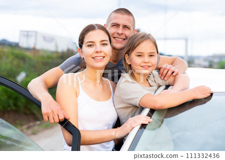 Happy family posing near new car 111332436