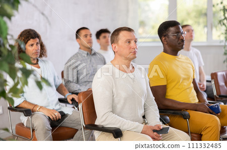 Group of men listening to lecture in auditorium attentively Group of men listening to lecture in auditorium attentively 111332485