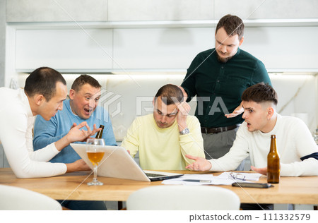 Concerned friends consoling man upset by online news 111332579