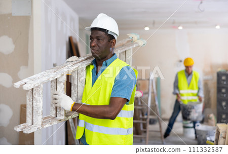 Man builder carrying stepladder Man builder carrying stepladder 111332587