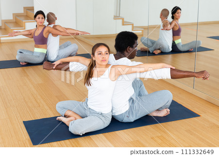 Couples practicing yoga with partner at studio Couples practicing yoga with partner at studio 111332649