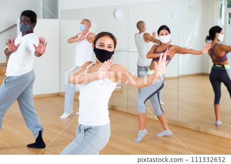 People in masks training in dance studio 111332652